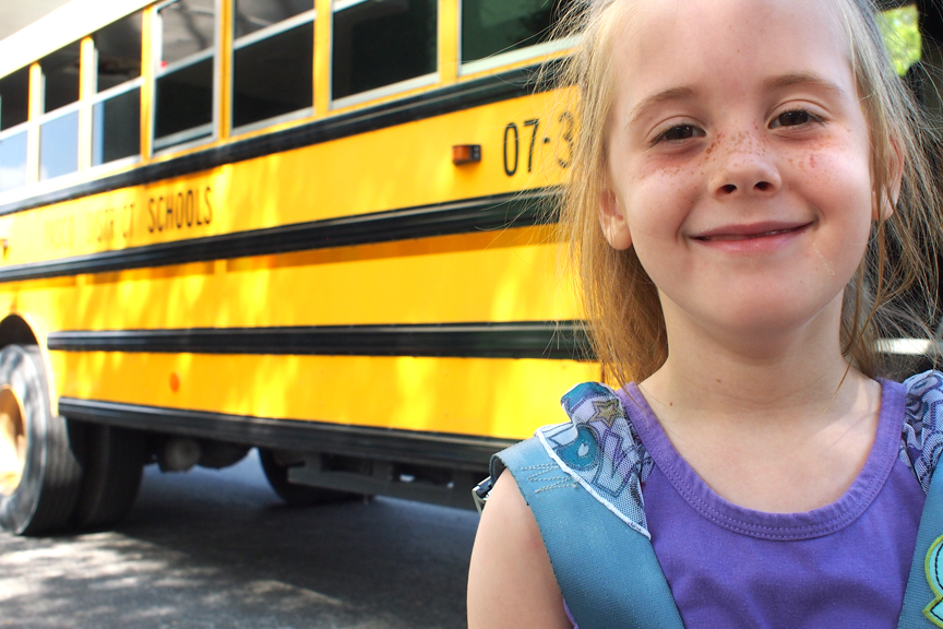 student in front of bus